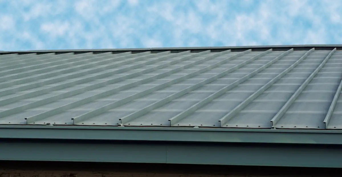 Close up of the edge of a green metal roof